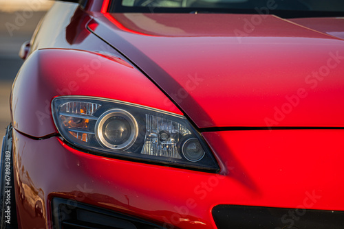 Close Up Red Sports Car Headlight and Bumper