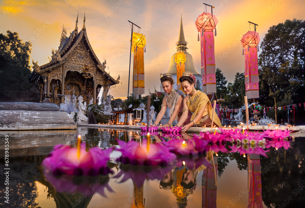 Fototapeta premium Loy Krathong Traditional Festival, Thai woman hold kratong, Thailand, Asia woman in Thai traditional dress hold kratong and bring Krathong to float Loi kratong day Thailand pray respect water goddess