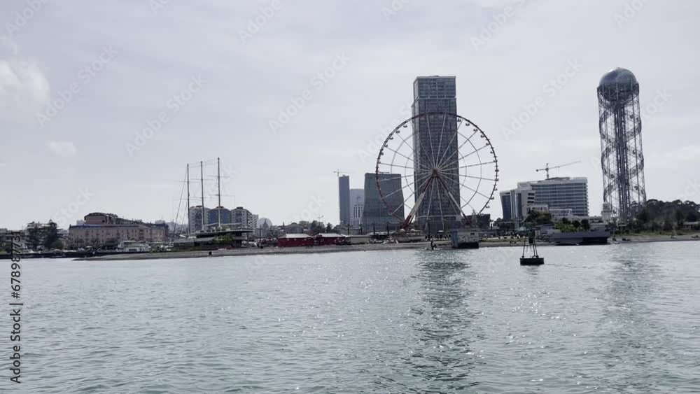 Shoreline with different buildings. The Black Sea. View from a floating boat. Shoreline with different buildings. The Black Sea. View from a floating boat.