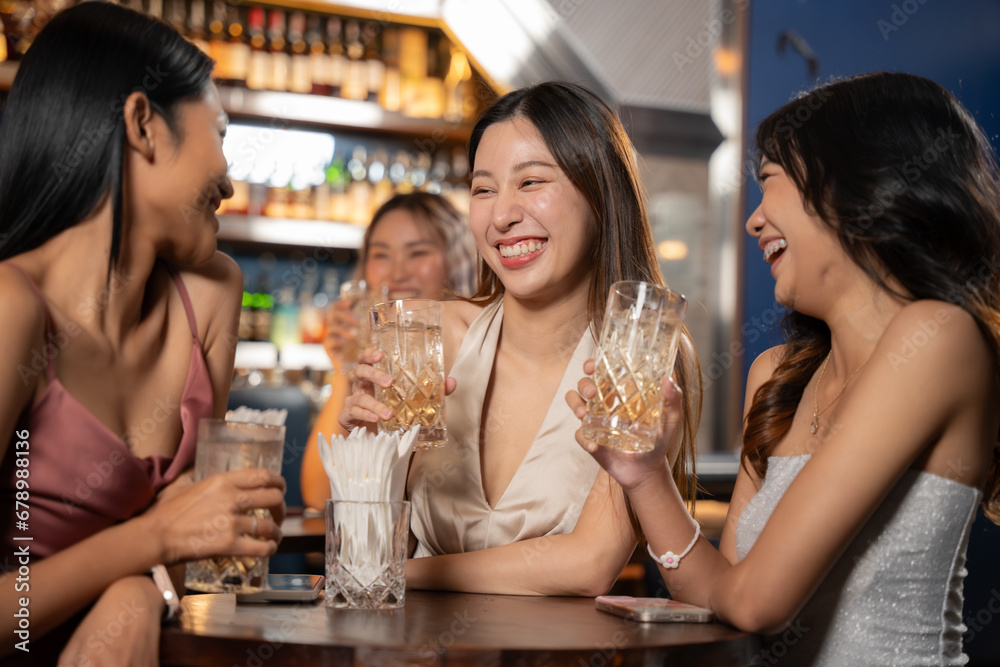 Beautiful Asian Woman Enjoying with Friend in Bar. They Enjoying with Night Party Together. Party, Lifestyle, Happiness, Cheerful and Celebration Concept. 