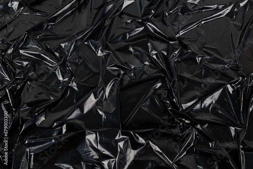 full frame abstract background of crumpled black plastic film bag
