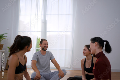 Group of people play yoga.
