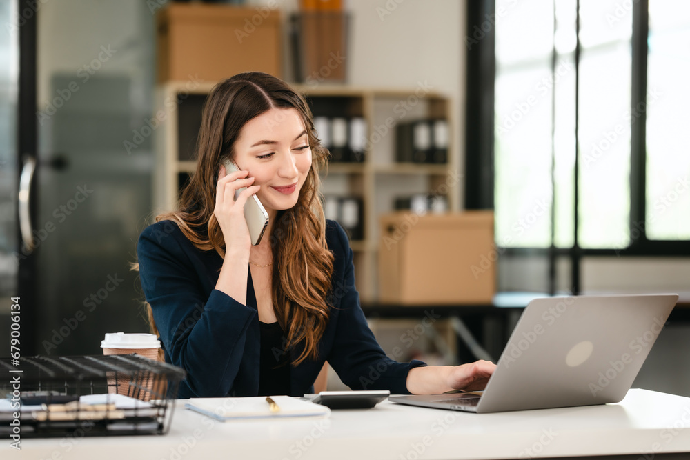 Attractive professional caucasian businesswoman working on her laptop, likely in an office setting, Balance Sheet, Accounting of Owners Equity, Cash Receipts Journal, Liabilities, Idle Capacity