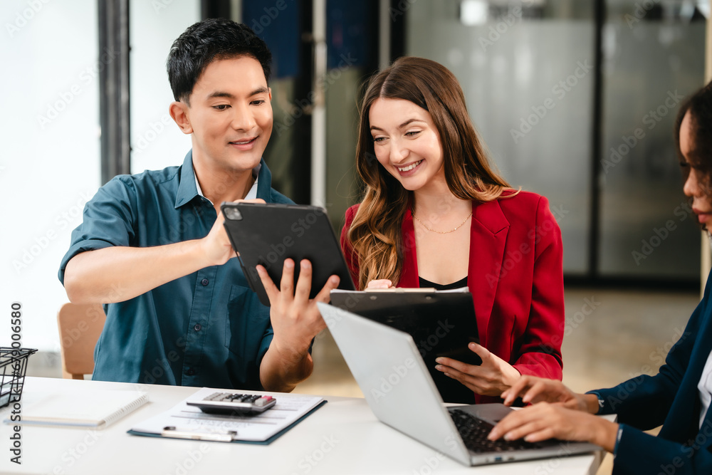 Fototapeta premium Diverse group of professionals engaging in discussion with laptop and clipboard, in bright office environment. qualified auditor report and opinion, asian people, african american, caucasian female