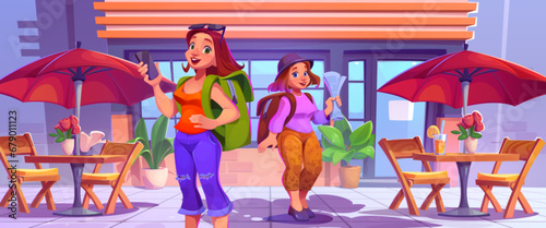 Young tourist girls at entrance to street cafe