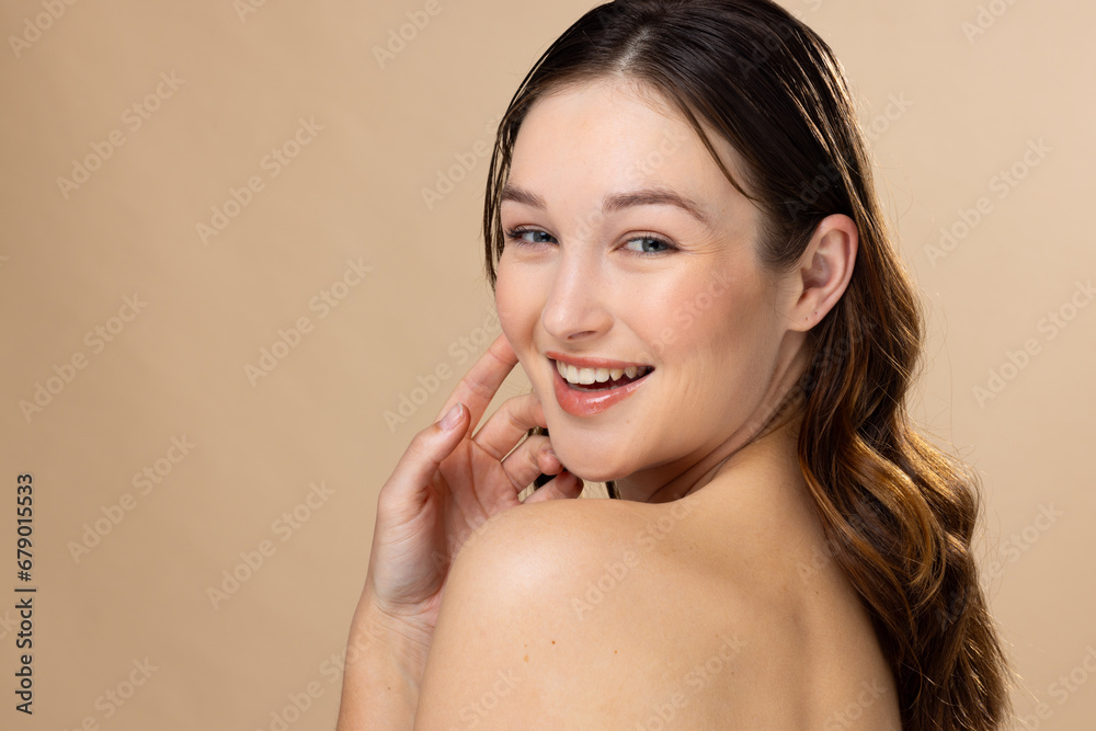 Portrait of caucasian woman with brown hair wearing natural makeup on beige background, copy space Portrait of caucasian woman with brown hair wearing natural makeup on beige background, copy space