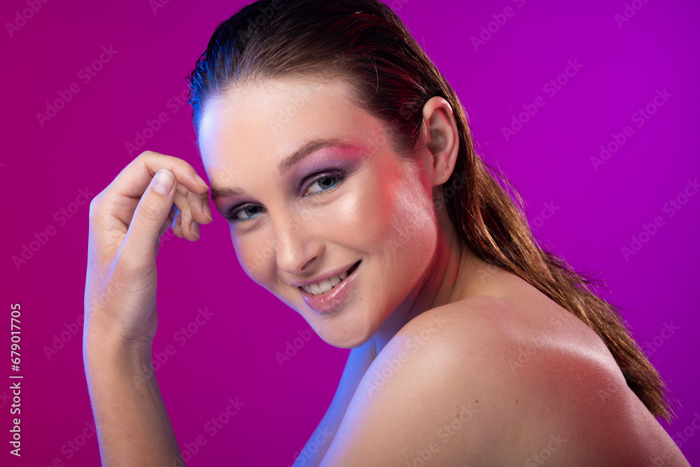 Portrait of caucasian woman wearing purple eye shadow on purple background Portrait of caucasian woman wearing purple eye shadow on purple background
