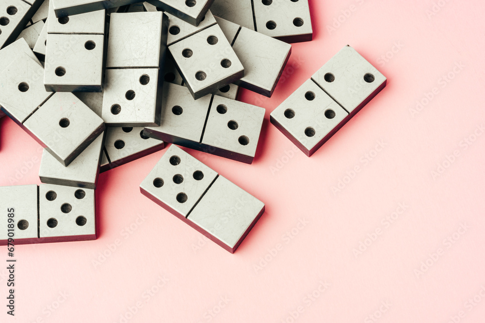 Domino tiles on pink background studio shot Domino tiles on pink background studio shot