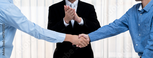 Corporate attorney applaud as business people seal a successful deal or agreement with handshake, celebrating mutually beneficial acquisition. Business handshaking concept. Panorama Rigid photo
