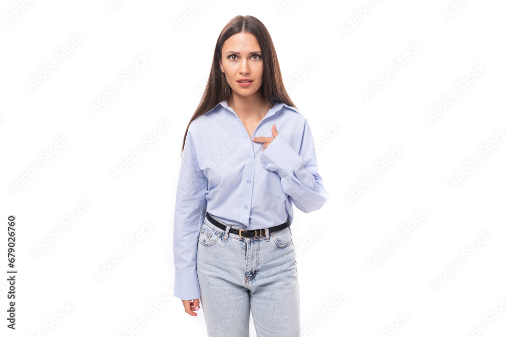 young stylish caucasian model woman with makeup and with dark straight hair dressed in a blue blouse on a white background with copy space young stylish caucasian model woman with makeup and with dark straight hair dressed in a blue blouse on a white background with copy space