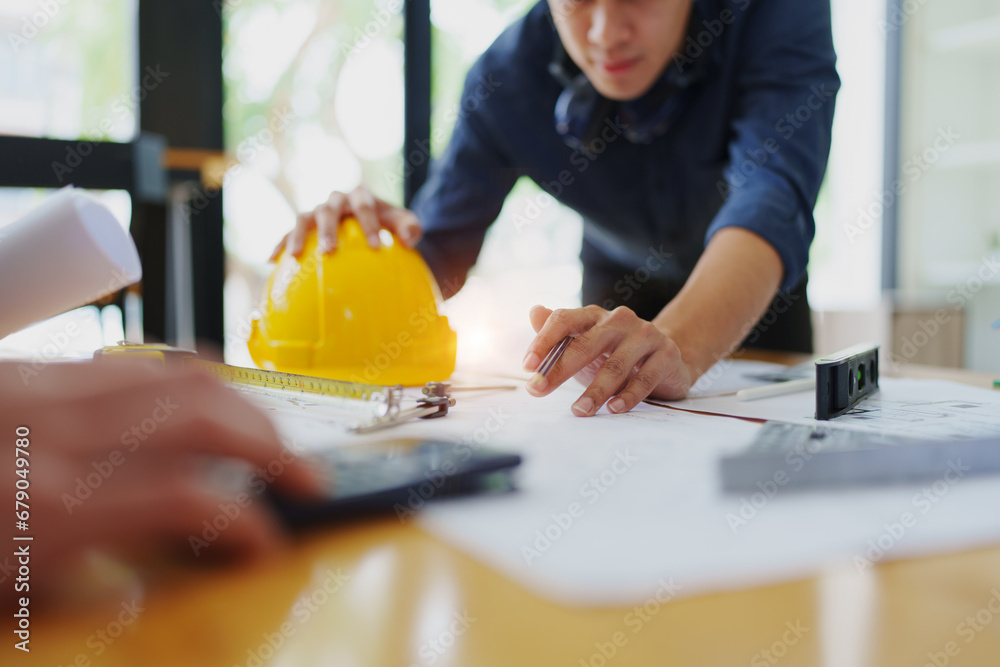 engineers discuss building on blueprint drawing, design building Project in office. engineers discuss building on blueprint drawing, design building Project in office.