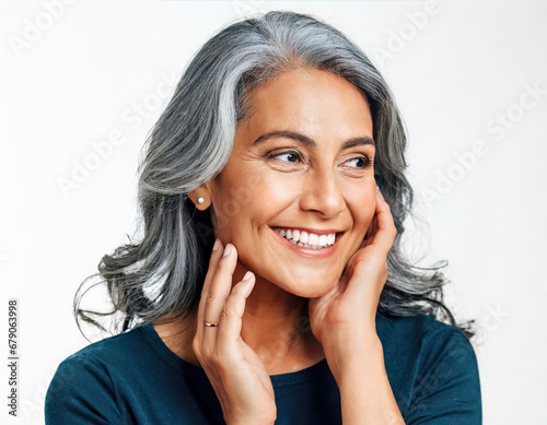 Beautiful aging mature woman. Adult woman with smooth and healthy skin in front of a white background.