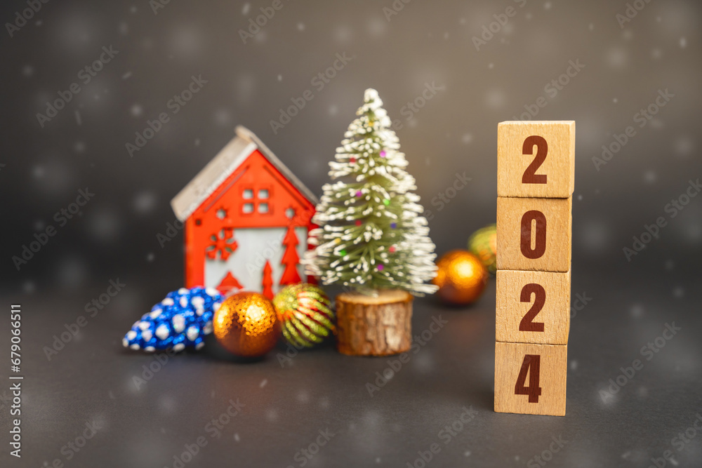 Blocks 2024, Christmas tree and red house. Merry Christmas and Happy New Year! Xmas concept. Festive winter holiday. Snowfall