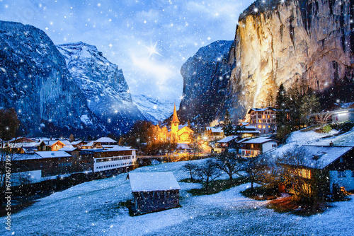 amazing touristic alpine village at night in winter with famous church and Staubbach waterfall  Lauterbrunnen  Switzerland  Europe © Melinda Nagy
