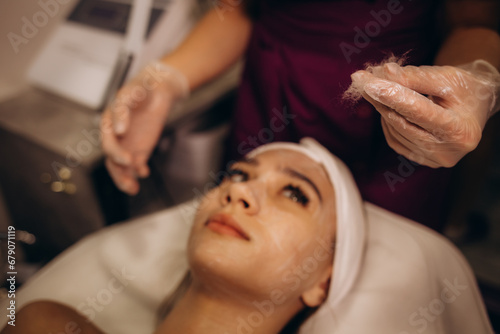 a cosmetologist performs a silky face procedure on a woman