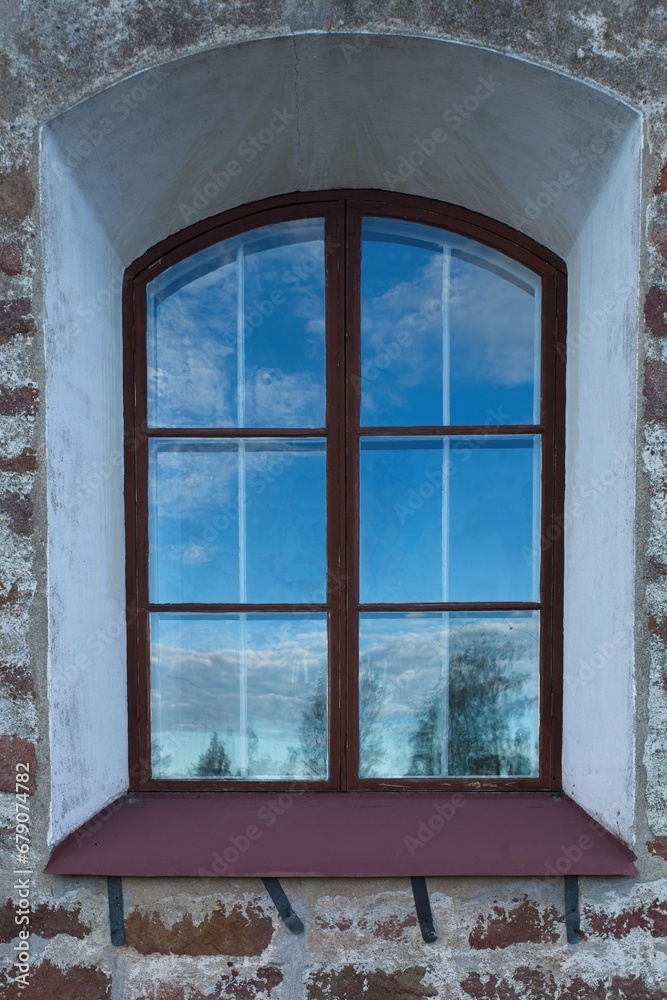 Old wood framed window on a stone building. Old wood framed window on a stone building.