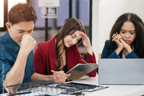 business people, teamwork, people and crisis concept - business team sitting sad and solving problems in the office.