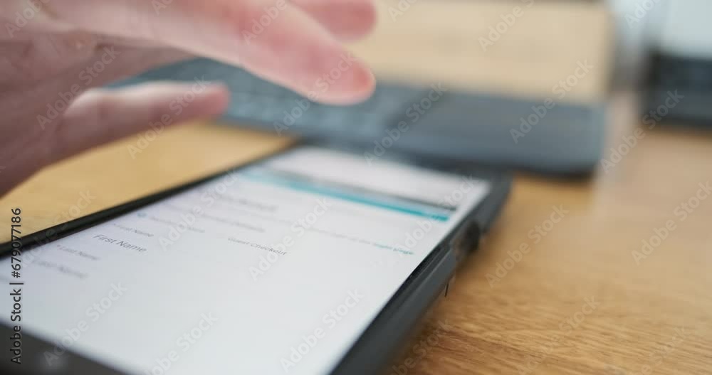 AMan's finger presses checkout button on smartphone screen. Side view, close-up. Concept of online payment, purchase, shopping. AMan's finger presses checkout button on smartphone screen. Side view, close-up. Concept of online payment, purchase, shopping.