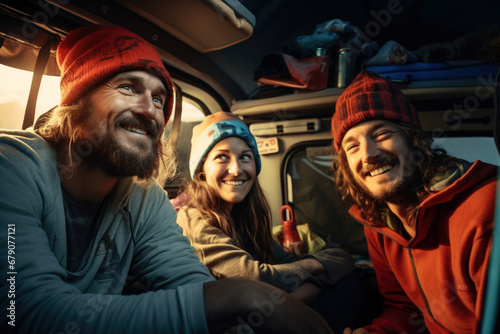 Happy smiling friends enjoying vacation together inside a camper van. Travel, vacation and freedom concept © pilipphoto