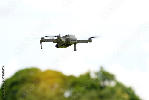 Asian high school students demonstrate flying drones or multirotor unmanned aerial vehicle technology. soft and selective focus.