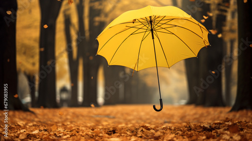 Yellow umbrella flying in a park in autumn photo