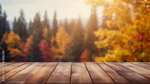 Empty wooden table over blurred autumn forest background. Ready for product display montage