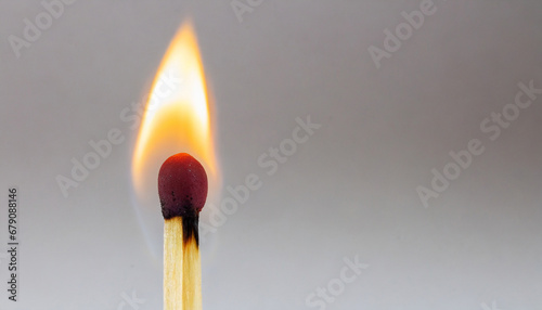 Macro photography of a burning match stick against white background