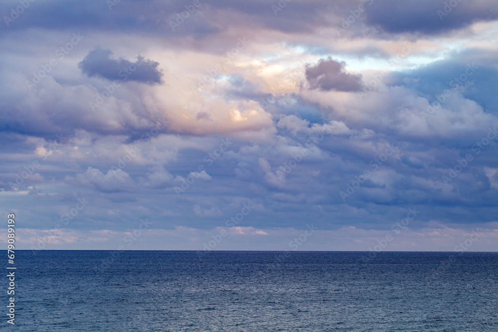 Sky in cloudy weather and sunset dark blue clouds on the sea, background