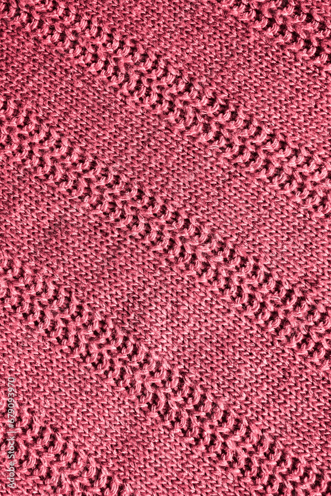 red knitted texture. Abstract background, pattern, ornament. Detail of a warm winter sweater.