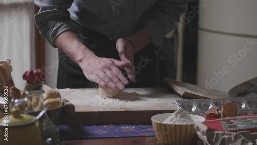 Homemade pasta. Man making pasta using pasta machine. Fresh traditional italian fettuccini comimg out of pasta maker. Tagliatelle maker home made. photo