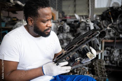 Men repairing car engine in auto repair shop, Selective focus. © Wosunan