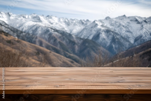 close up of a wooden table with the mountains covered with snow in winters © DailyLifeImages