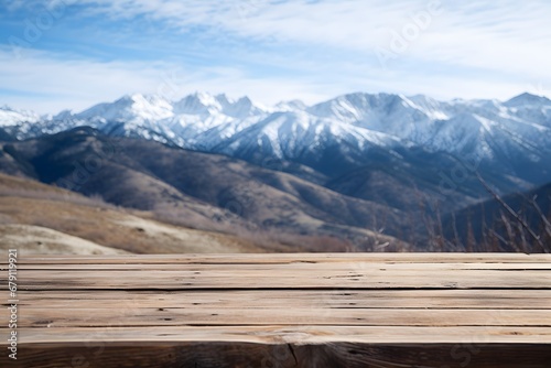 close up of a wooden table with the mountains covered with snow in winters