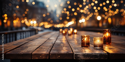 Christmas background. Empty wooden table on the background of the New Year's golden bokeh. Ready for product montage.There are Christmas candles on the edge of the table.