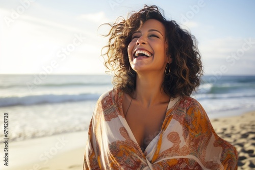 Happy mature latin woman at the beach photo