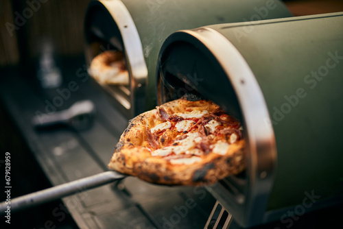 Close-up of a freshly baked pizza, getting right from the oven. photo