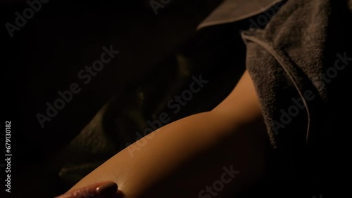 Close-up of a woman's leg being massaged in the calf area. Relaxing massage.