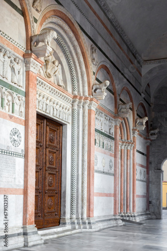 Main door of Lucca Cathedral. It is a Roman Catholic cathedral dedicated to Saint Martin of Tours in Lucca, Tuscany, Italy. The doors of the church are closed and no one is there.