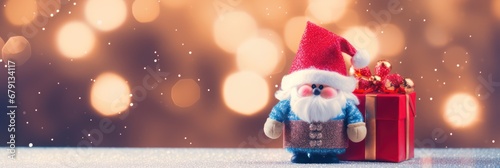 Cute Santa Claus holding a gift box standing in front of the Merry Christmas lighting background with lighting decoration photo