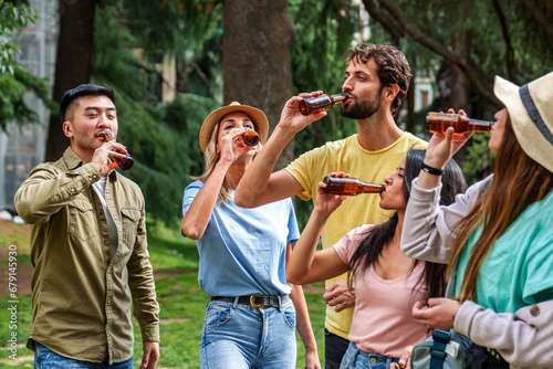 Картината върху платно Five friends share laughter and drinks outdoors surrounded by greenery, embodying leisure and companionship