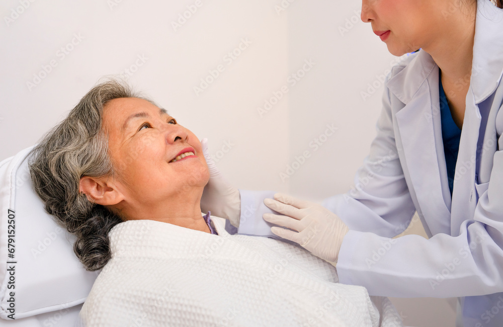 Fototapeta premium asian senior woman smile when cosmetologist touching her face to check her facial skin condition for cosmetic treatment at aesthetic clinic