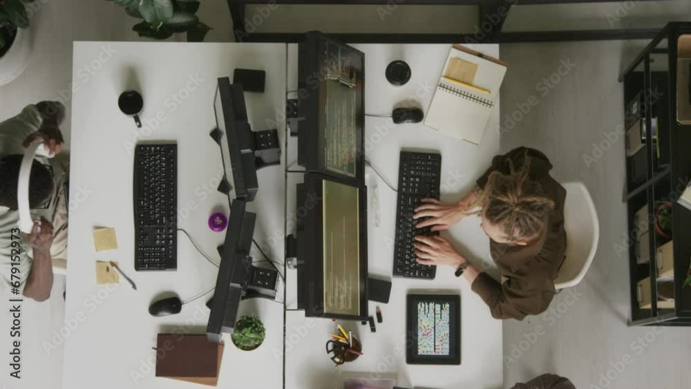 Computer Programmers Table Top View Top view of multiracial programmers coding on desktop computers while ...