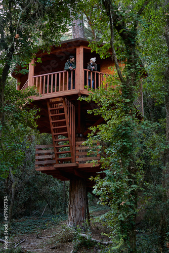 Romantic couple in tree house in forest.