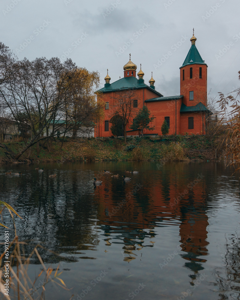Orthodox church in the Dnieper near the water. St. Nicholas Church. Overcast weather. Religion, faith.