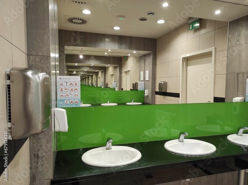 public toilet. modern public toilet interior. commercial bathroom. reflection in the mirror