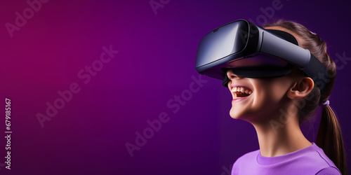 Young girl getting experience using VR headset glasses isolated on a blue background with copy space