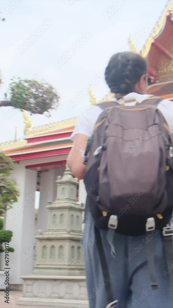 Solo traveler with a backpack and camera explores Buddhist temples and pagodas in Thailand, embracing the summer adventure. Dive into Thai culture and Buddhism with this Asian exploration Solo traveler with a backpack and camera explores Buddhist temples and pagodas in Thailand, embracing the summer adventure. Dive into Thai culture and Buddhism with this Asian exploration