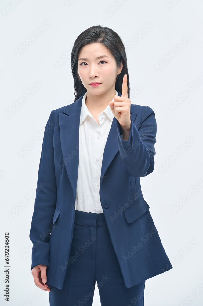 A young businesswoman in a suit is making various facial expressions and gestures. A young businesswoman in a suit is making various facial expressions and gestures.
