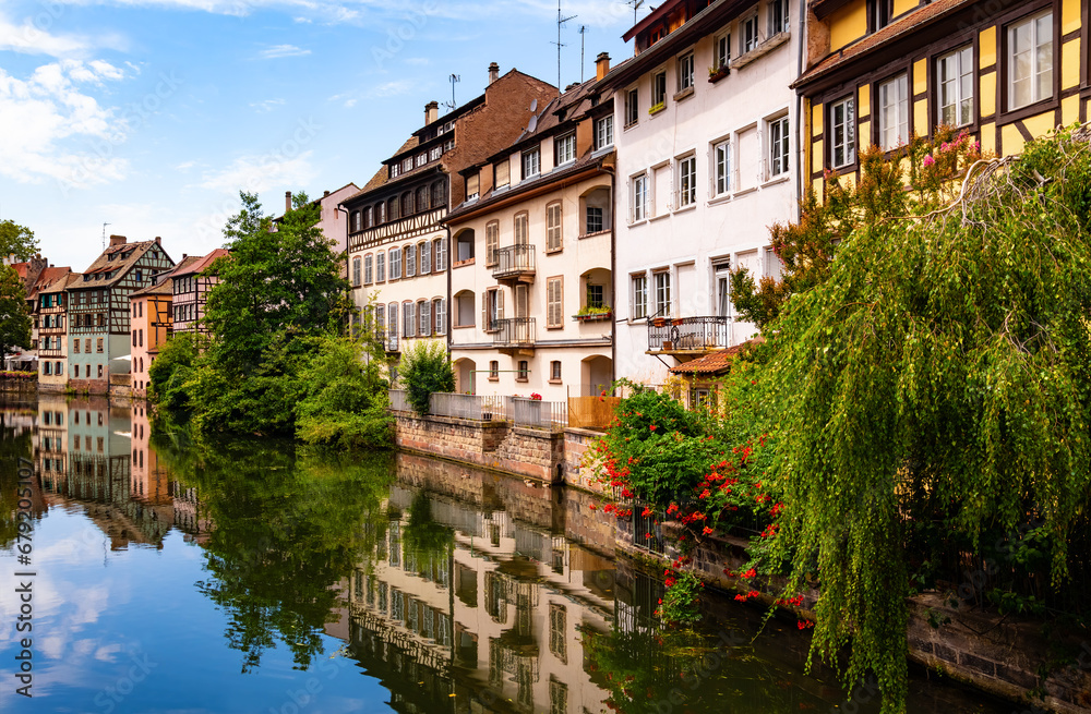 La Petite France is a picturesque “quartier“ in Strasbourg in Alsace, France. Panoramic view of colorful truss houses on the waterfront of old town channel system. Major tourist destination and sight.