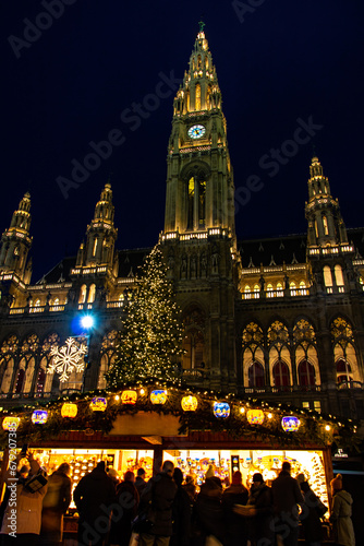 Photography The illuminated shop at traditional Christmas market in front of Rathaus - City hall at Vienna, Austria